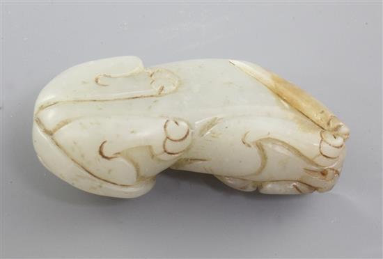 A Chinese pale celadon and russet jade figure of a recumbent beast, Qing dynasty, 5.1cm